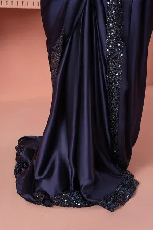 Elegant dark silk saree with sequin embellished border on neutral background