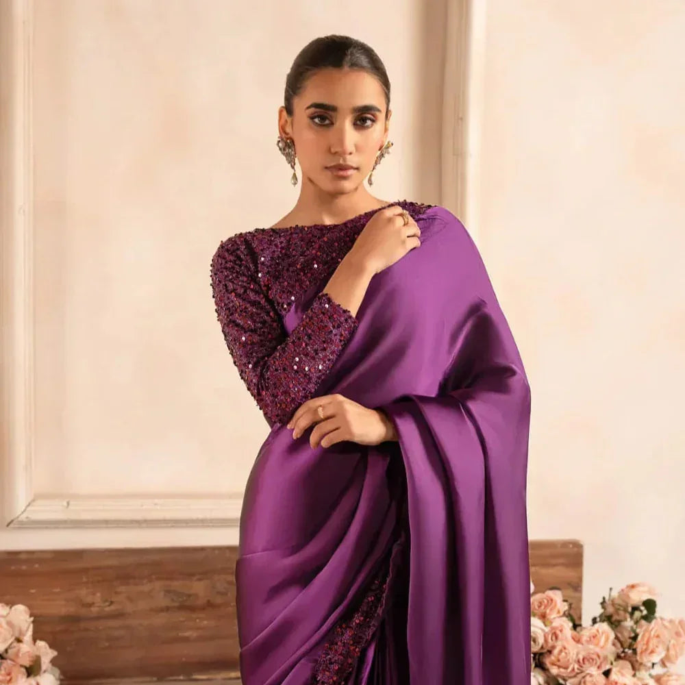 Woman wearing elegant purple sequin saree, premium fabric, floral background, stylish attire