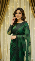 Woman in elegant green embroidered saree posing indoors with curtain and fairy light backdrop
