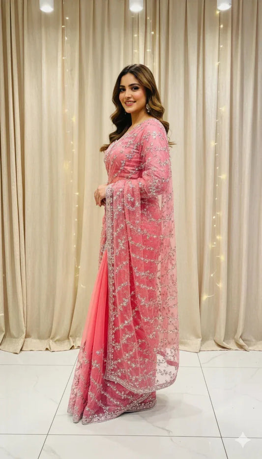 Woman in pink embroidered saree posing indoors, Sareeium jan fashion shoot
