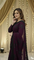 Woman in elegant purple saree with black floral embroidery, Sareeium jan collection, festive backdrop