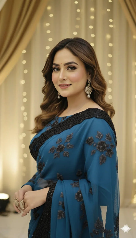 Woman in blue embroidered saree with wavy hair at Sareeium jan, elegant festive backdrop