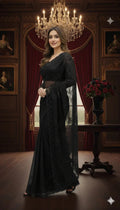 Woman in elegant black saree standing in a luxurious room with chandelier, Sareeium jan fashion