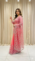 Woman in pink embellished saree posing indoors, elegant ethnic wear from Sareeium jan