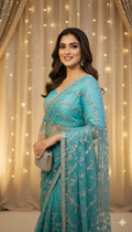 Woman in elegant blue embroidered saree holding clutch, Sareeium jan fashion backdrop