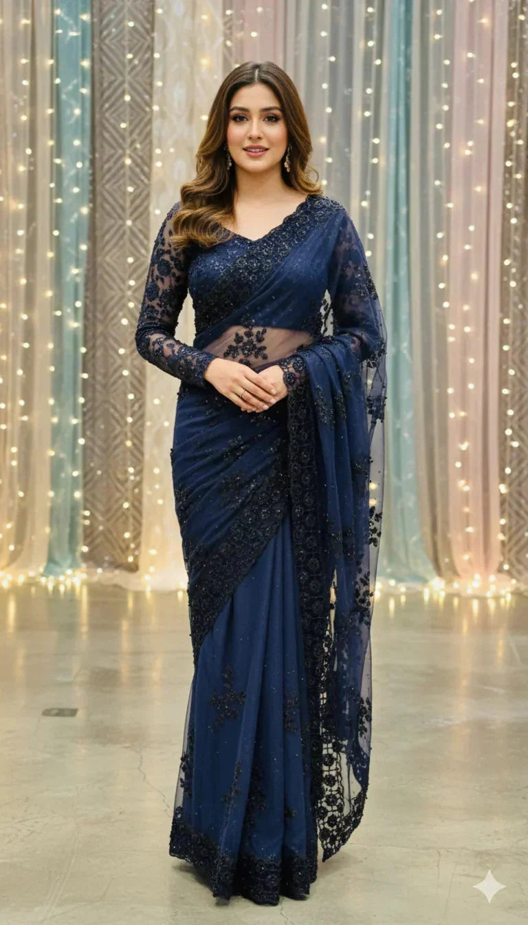 Woman in navy blue saree with lace details, posing indoors, Sareeium jan collection