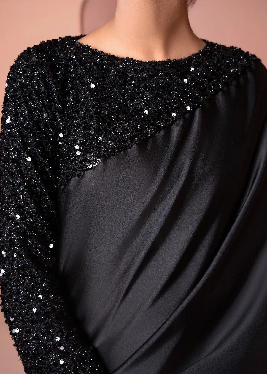 Black sequin embellished fabric with elegant drape and shiny textured details