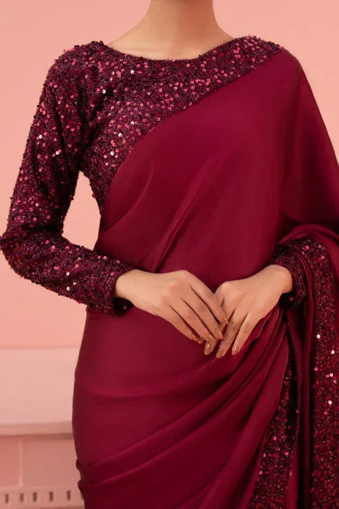 Woman wearing a maroon sequin embellished saree, elegant evening fabric design